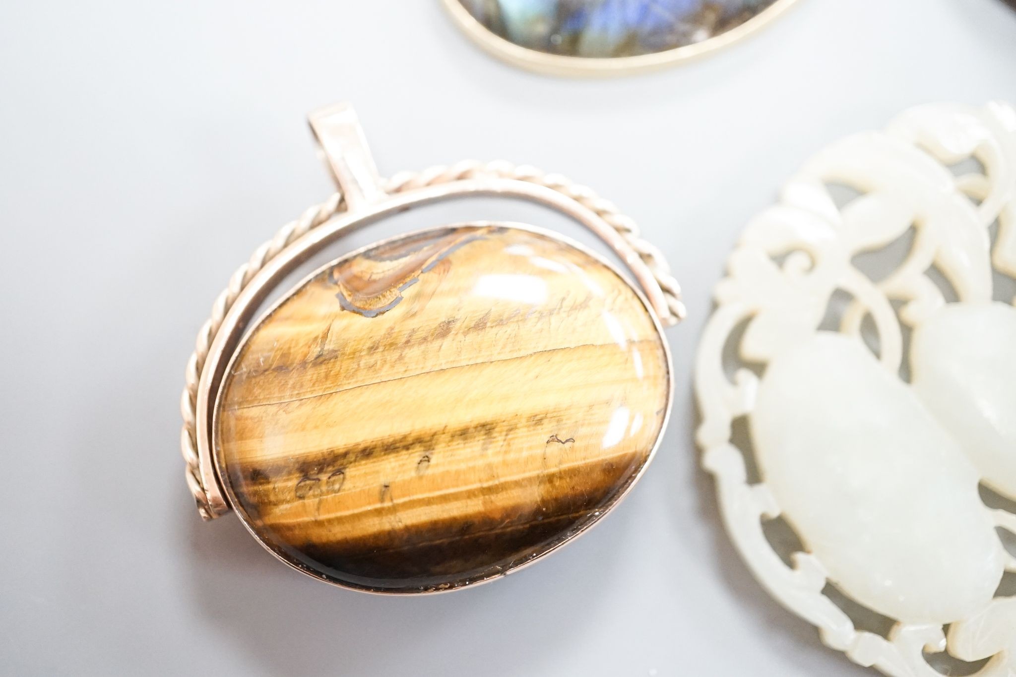 A 19th century gilt metal mounted brooch, with inset oval painted wax bust of a lady to dexter, 60mm and four other items including a 9ct mounted oval tiger's eye quartz pendant.